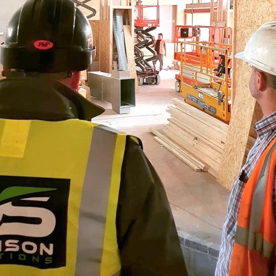 Davison Solutions workers on site in hard hats and hi-vis bibs.