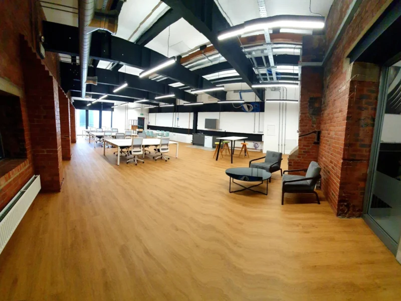 A large, modern office with simple furniture.