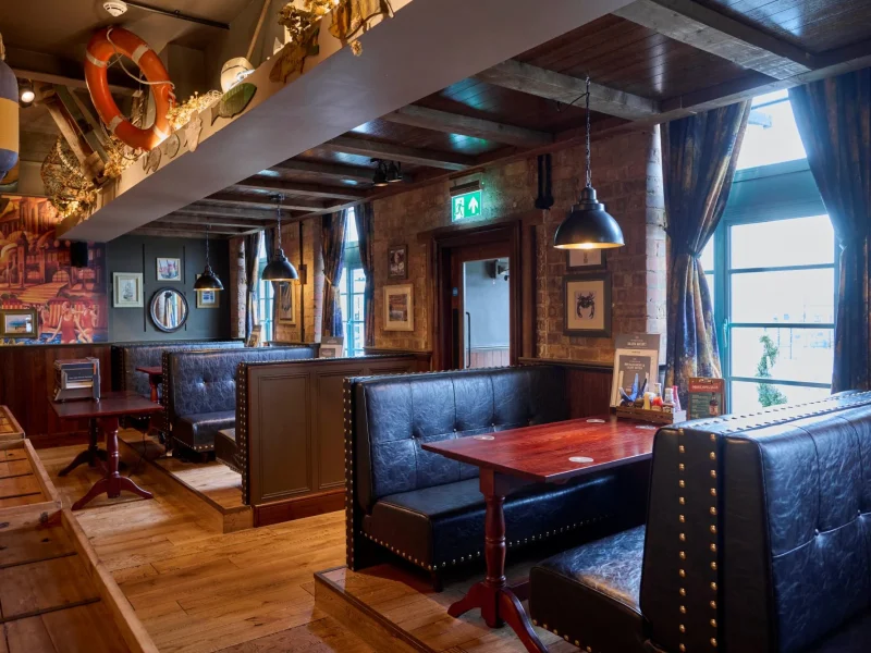 Dark leather seating booths in the Tynemouth Castle Inn.