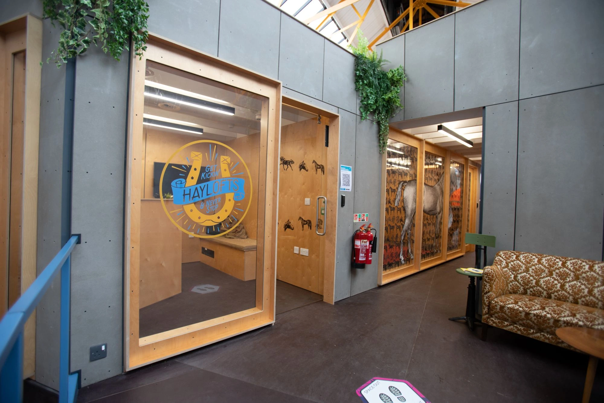 Industrial chic grey partition walls with large windows, creating airy office spaces at Haylofts, Newcastle. 
