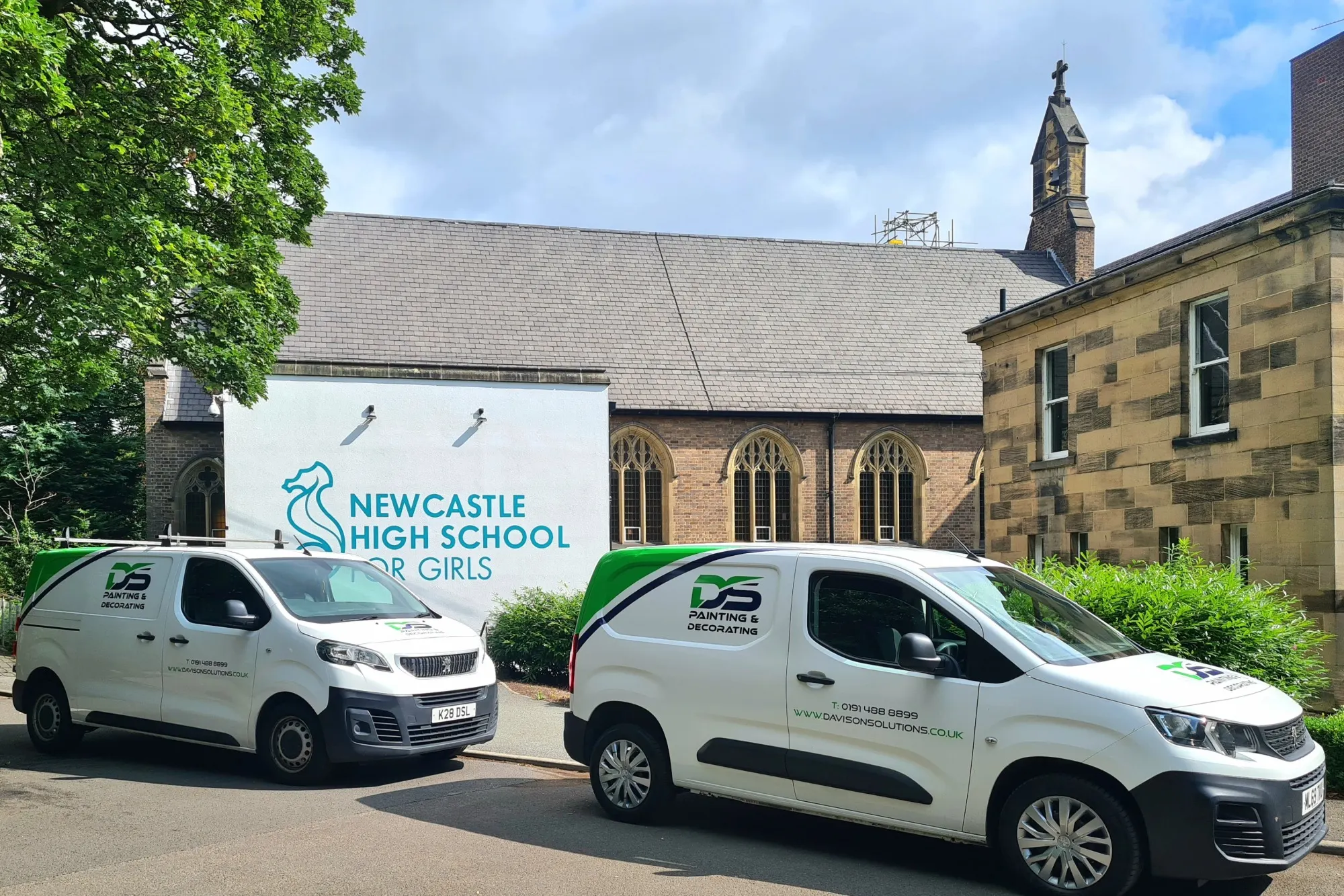 Two Davison Solutions branded vans outside Newcastle High School for Girls building.