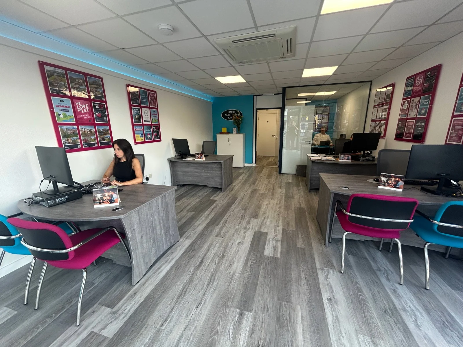 The new interior of the RMS Ryton branch with branded furniture and people working.